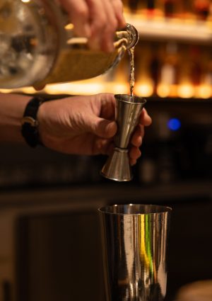 Pouring a drink at The Office Cigar Bar & Lounge