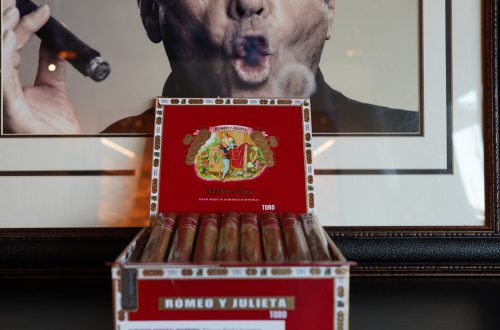 A box of Romeo Y Julieta cigars in front of a picture at The Office.